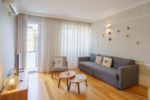 a living room with a couch and a table at Feel Porto Downtown Apartments & Studios in Porto