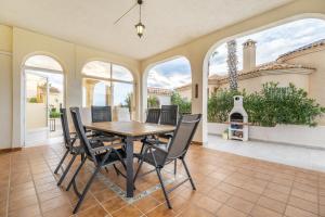 a dining room with a table and chairs and a fireplace at Las Ramblas in Orihuela