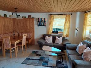 a living room with a couch and a table at Urlaub an der Grenze in Lauterbach +36 photos