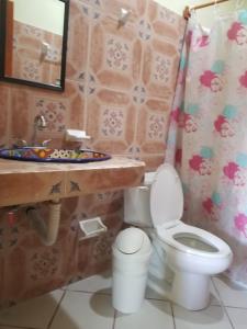 a bathroom with a toilet and a sink at HOTEL ATLANTIDA in Playa del Carmen