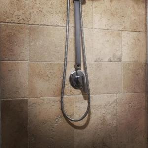 a shower with a hose attached to a wall at Dependance Giardino in Umbertide