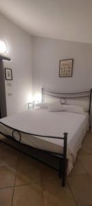 a bedroom with a large white bed in a room at Dependance Giardino in Umbertide +33 photos