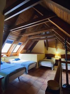 a bedroom with two beds in a room with wooden ceilings at Aparthotel Es de Don Joan in Unha