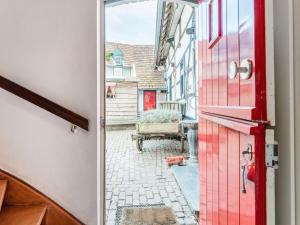 a red door with a view of a street at Beautiful holiday home in Voerendaal in Voerendaal +32 photos