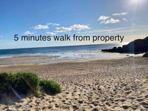 a beach with the words minutes walk from property at Coastal Retreat-NEW DAY PROPERTIES-next to beach in South Shields