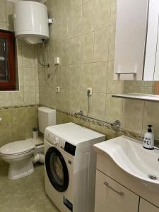 a bathroom with a washing machine and a sink at Apartment Seman in Vela Luka