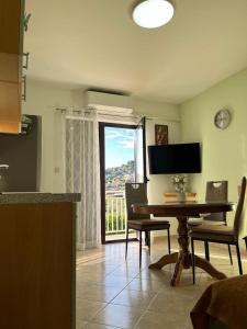 a kitchen with a table and chairs and a window at Apartment Seman in Vela Luka