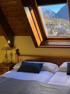 a bedroom with a bed with a large window at Aparthotel Es de Don Joan in Unha