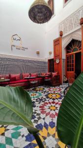 a lobby with couches and a colorful tile floor at Riad Fes Touria Palace in Fez