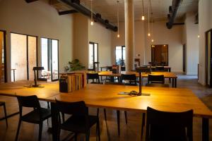 a large room with wooden tables and chairs at BlackBrick Sandton Two in Johannesburg