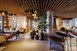 a restaurant with chairs and tables and a lobby at Altapura in Val Thorens