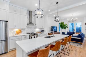 a kitchen with white cabinets and a kitchen island with bar stools at Park West 7 in Nashville