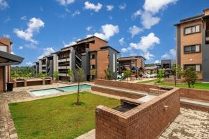 an image of an apartment complex with a courtyard at The Lillies Luxury Apartment in Midrand