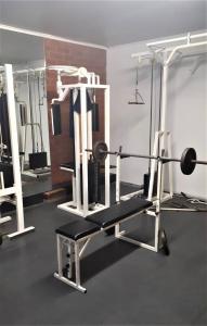 a room with a gym with a bench and weights at House Rhodopi in Maldegem