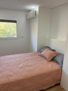 uma cama num quarto com uma janela em Casa dos Doces em Póvoa de Lanhoso
