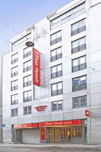 a white building with a red sign on it at Thon Hotel Cecil in Oslo