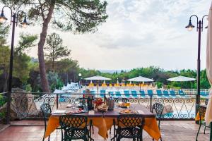 a table and chairs on a patio next to a pool at Le Pianacce Camping Village in Castagneto Carducci