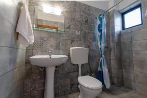 a bathroom with a toilet and a sink at Anthia Apartments in Marmari