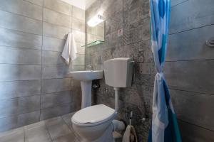 a bathroom with a toilet and a sink at Anthia Apartments in Marmari