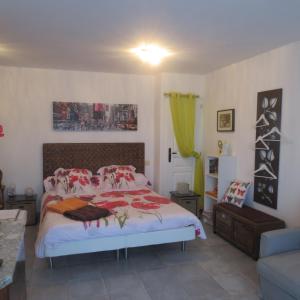 a bedroom with a bed with red and white pillows at Mas Myro in Uzès