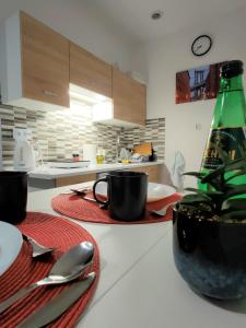 una cocina con una mesa con platos y una botella en Studio Piekary 1-go Maja, en Piekary Śląskie