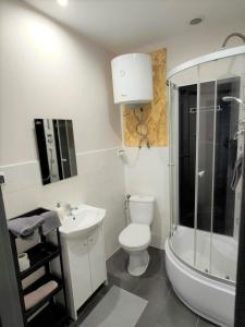 a white bathroom with a toilet and a sink at Studio Piekary 1-go Maja in Piekary Śląskie