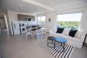 a living room with a white couch and a table at 3 ambientes en Complejo de Lujo in Pinamar