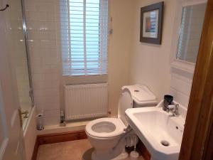 a bathroom with a toilet and a sink at Belv House in Weymouth