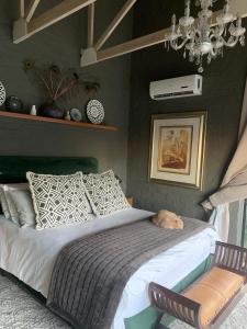 a bedroom with a bed with a cat laying on it at Eagles Nest in Cape Town