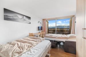 Posteľ alebo postele v izbe v ubytovaní Chaleureux studio à Anzère, accessible à ski, proche de tout