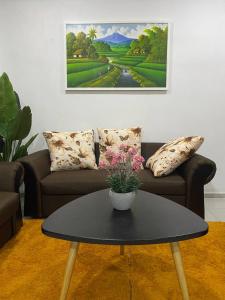 a living room with a couch and a table at Islamic Homestay Promenade Tanjung Lumpur in Kuantan