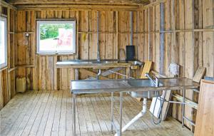 a room with two desks in a wooden house at Lovely Apartment In Sandstad With Wifi in Skipnes