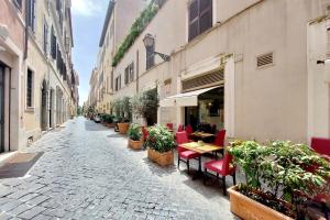 an empty street with tables and chairs and plants at Loft Margutta per Smart Worker in Rome