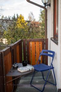 a blue chair sitting on a table on a balcony at Berlin entspannt geniessen in Berlin