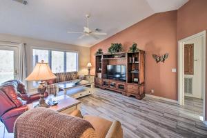 a living room with a couch and a tv at Lovely Hot Springs Home with Lake Balboa Access in Hot Springs Village