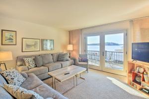 a living room with a couch and a tv at Lakefront Hot Springs Condo with Boat Dock! in Hot Springs