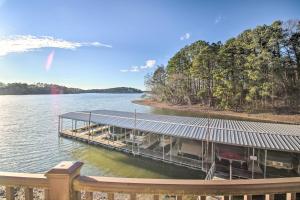 a dock on a body of water with trees at Lakefront Hot Springs Condo with Boat Dock! in Hot Springs