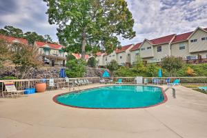 a swimming pool with chairs and umbrellas at a resort at Lakefront Hot Springs Condo with Boat Dock! in Hot Springs