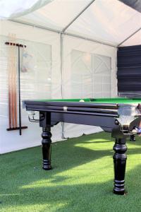 a pool table in a tent withgrass at Refael Garden Villa 