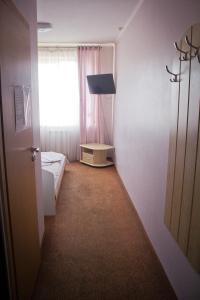 a room with a bedroom with a bed and a window at Motel in Ivano-Frankivsʼk