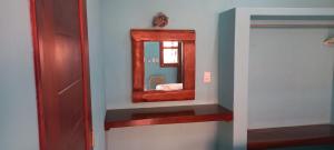 a mirror on a wall next to a room at Hotelito Villas Holbox in Holbox Island