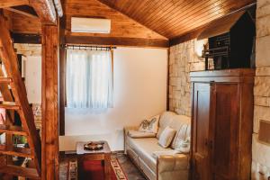 a living room with a couch and a wooden ceiling at River fantasy ( Mrežnička fantazija ) in Duga Resa