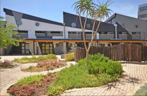 a building with a palm tree in a courtyard at Maboneng Precinct Johannesburg - Craftsmenship Apartments in Johannesburg