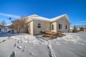 a house with a picnic table in the snow at Spacious Idaho Home Ski, Hike, and Fish! in Rexburg