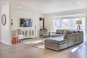 a living room with a couch and a fireplace at Peaceful Windsor Retreat with Private Hot Tub! in Windsor