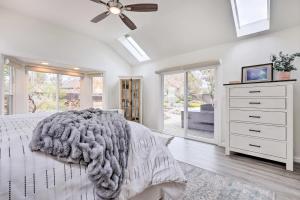 a bedroom with a bed and a ceiling fan at Peaceful Windsor Retreat with Private Hot Tub! in Windsor