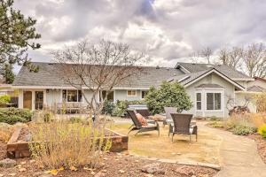 a house with a patio and chairs in a yard at Peaceful Windsor Retreat with Private Hot Tub! in Windsor