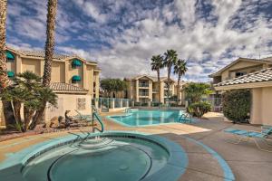 a swimming pool in a resort with palm trees and condos at Laughlin Mtn Getaway 2 Mi to Colorado River in Laughlin