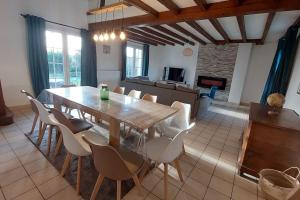 jadalnia z drewnianym stołem i krzesłami w obiekcie La villa du lac à Mesnil Saint Père w mieście Mesnil-Saint-Père