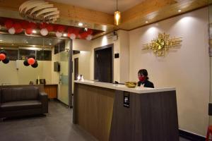 a woman sitting at a counter in a restaurant at HOTEL MONTANA VYOO in Namchi